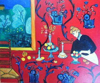 Intérieur rouge table fleurs femme assise motifs décoratifs hommage Matisse